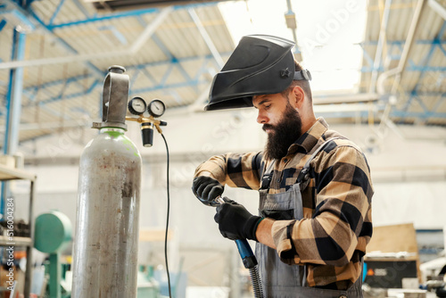 Cuadro en lienzo A metallurgy worker preparing welder for work in factory.