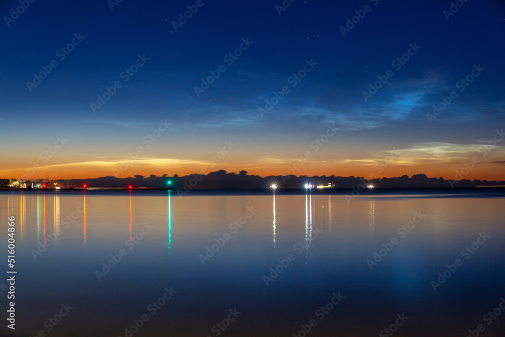 Noctilucent clouds over the Gdynia cityscape at night. Poland