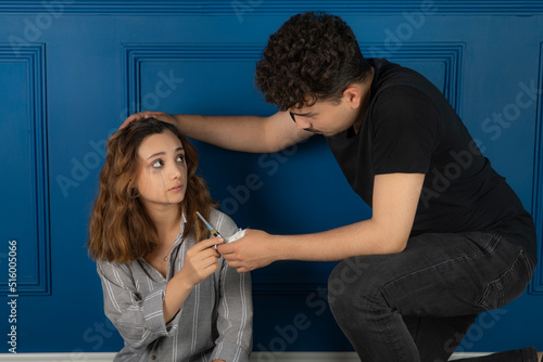 Young man giving injection to a dick to the girl.
