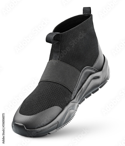 Black high-top sneaker without shoelaces stands on the tip isolated on white background. Sports shoe with clipping path.