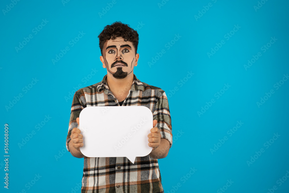 Creative young guy holding white idea board and seems upset Creative young guy holding white idea board and seems upset