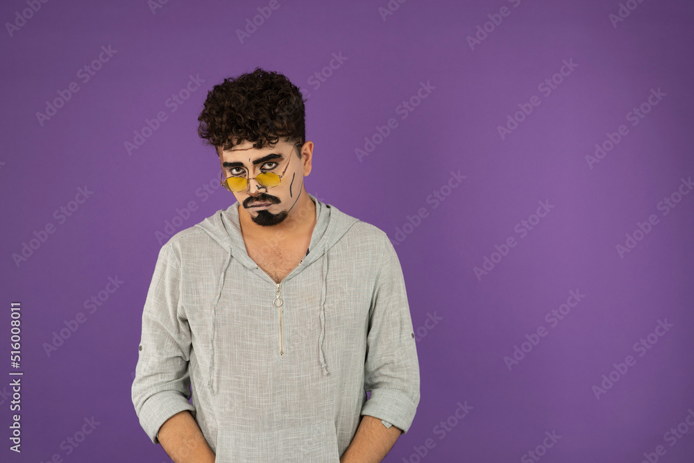 Upset young man with pop art makeup looking at camera Upset young man with pop art makeup looking at camera