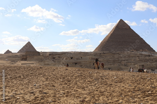 Pyramids of Giza. Scene with tourists near pyramid in Egyptian desert. Travel to the African continent for look of a UNESCO World Heritage Site. 