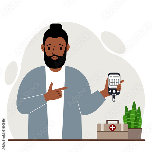 Sad man holds a glucometer in his hand. The concept of blood sugar control, diabetic.