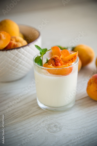 Healthy breakfast of homemade yogurt in a glass with fresh apricots