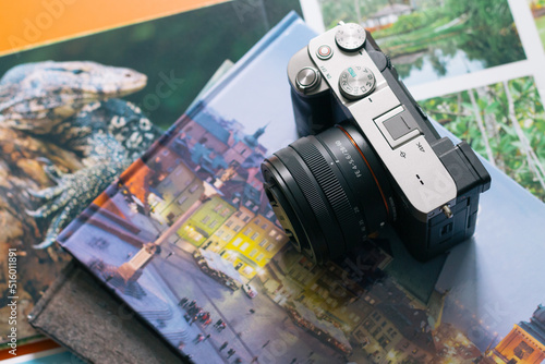 Camera with photo albums on orange table