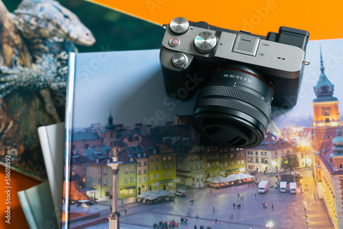 Camera with photo albums on orange table