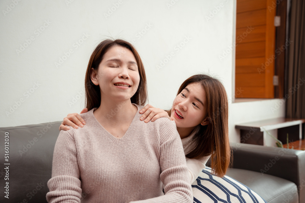 Asian young daughter massaging mid age mother for relax enjoy together happy family at home, relieve office syndrome concept. Asian young daughter massaging mid age mother for relax enjoy together happy family at home, relieve office syndrome concept.