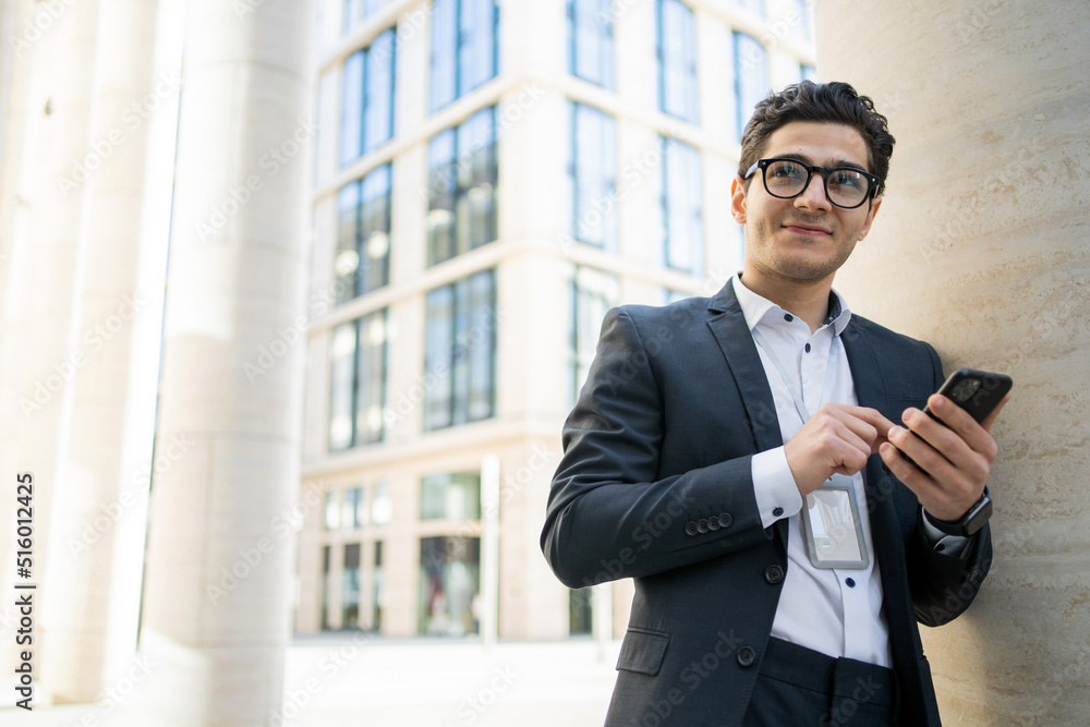 The manager uses the phone a man with glasses works from the office in a suit The manager uses the phone a man with glasses works from the office in a suit