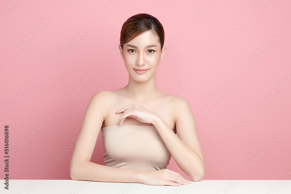 Obraz premium Beautiful young asian woman with clean fresh skin on pink background, Face care, Facial treatment, Cosmetology, beauty and spa, Asian women portrait.