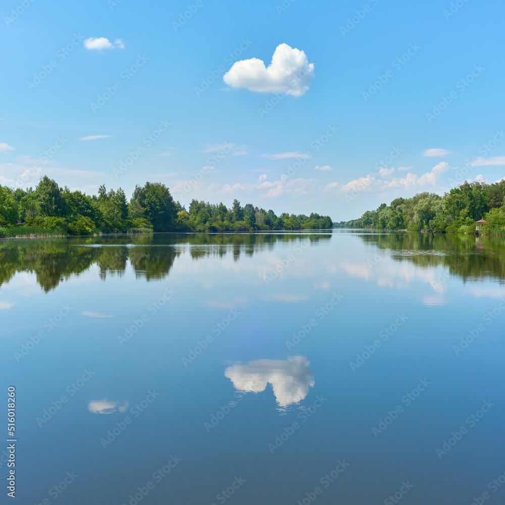 Peaceful summer landscape with clouds on the blue sky over the river near Kyiv city in Ukraine. Peaceful summer landscape with clouds on the blue sky over the river near Kyiv city in Ukraine.