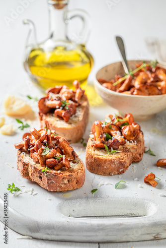 Tasty and fresh toasts with chanterelles, parmesan cheese and herbs.