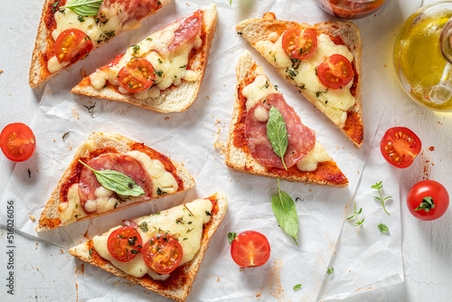 Crunchy and vegetarian toasts with salami, cheese and basil.