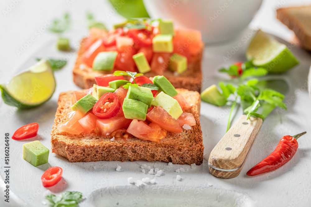 Crunchy and delicious toasts with avocado, tomatoes and coriander. Crunchy and delicious toasts with avocado, tomatoes and coriander.
