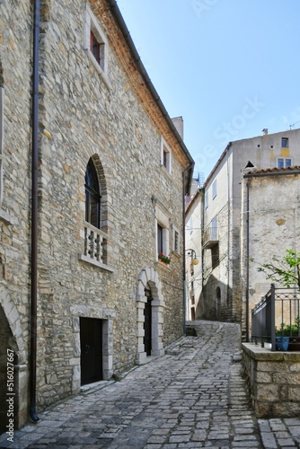 Fototapeta Naklejka Na Ścianę i Meble -  A narrow street between the old houses of Pietragalla, a village in the Basilicata region, Italy.