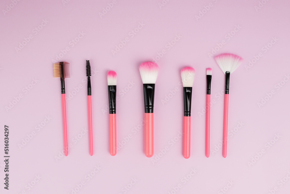 makeup brushes on a pink background, a set of cosmetics for applying powder, blush, foundation makeup brushes on a pink background, a set of cosmetics for applying powder, blush, foundation