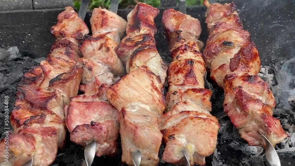 kebabs are grilled on coals on a grill with smoke kebabs are grilled on coals on a grill with smoke