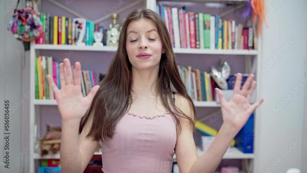 The young brunette gesticulates and sings while looking directly into the camera. The young brunette gesticulates and sings while looking directly into the camera.