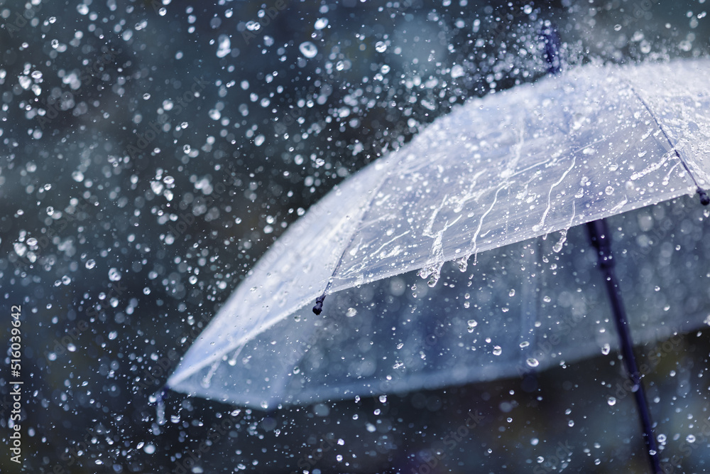 Transparent umbrella under heavy rain against water drops splash background. Rainy weather concept. - obrazy, fototapety, plakaty 