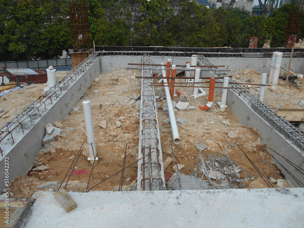 SELANGOR, MALAYSIA -JUNE 5, 2022: Toilets underground sewerage pipes installed at construction sites before floor concrete is poured. Setting out the position opening is marked by the surveyor.
