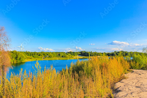 Beautiful quarry lake dredging pond lake blue turquoise water Germany. © arkadijschell
