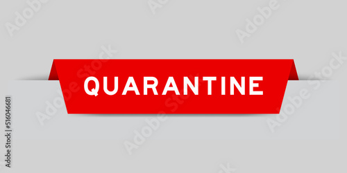 Red color inserted label with word quarantine on gray background