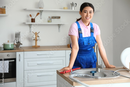 Asian female plumber near s...