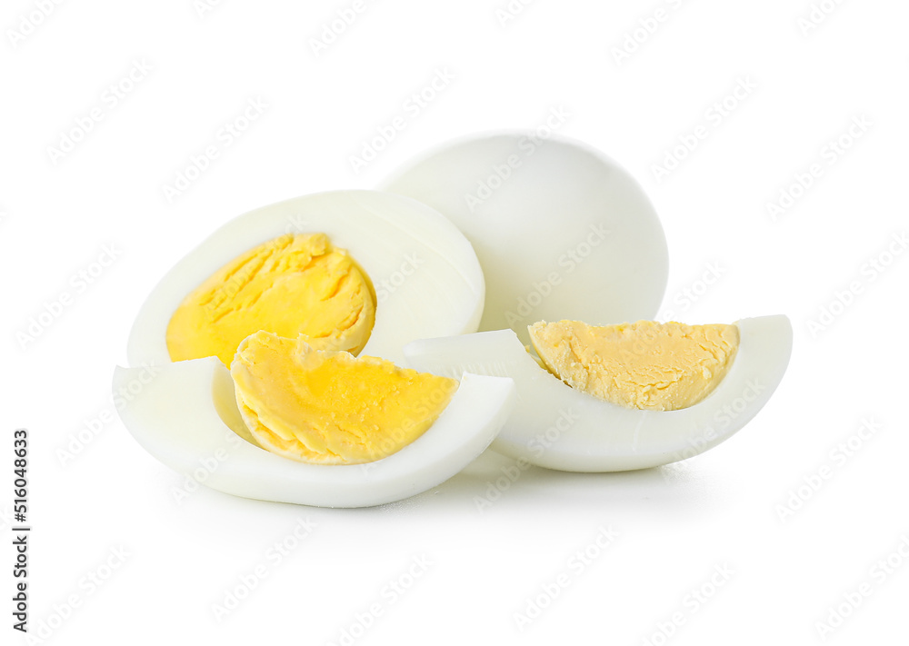 Pieces of boiled chicken eggs on white background