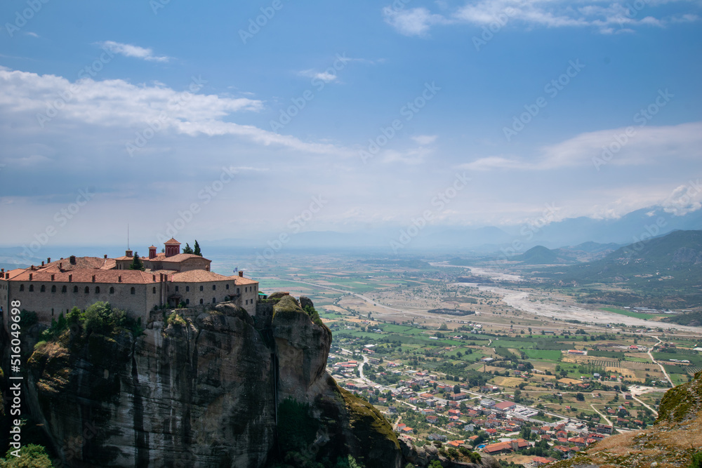 View of a Orthodox monastery and Kalabaka town from the top of the iconic rocks of Meteora in Greece