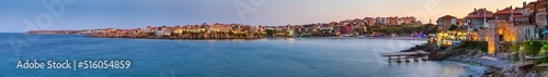 Seaside landscape, panorama, banner - view of the embankment with fortress wall during sunset in the city of Sozopol on the Black Sea coast in Bulgaria. © rustamank