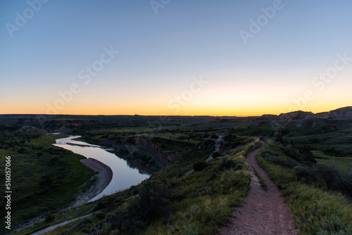 A sunset over a hiking path that looks over the Missouri River at Theodore Roosevelt National Park in North Dakota