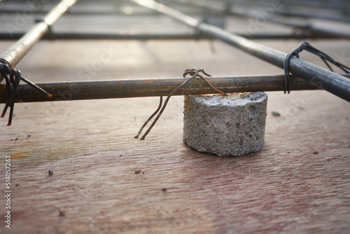 Aspro Spacer. Concrete spacer block are placed under wire mesh structural steel panels on construction site. photo