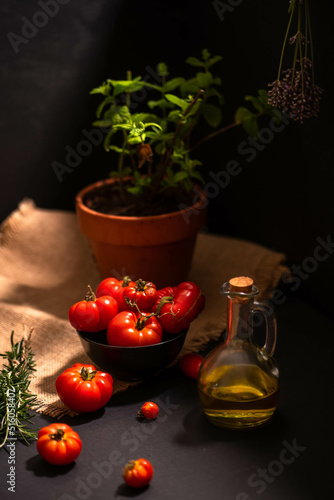organic garden tomatoes prepared for cooking with olive oil, garlic and rosemary