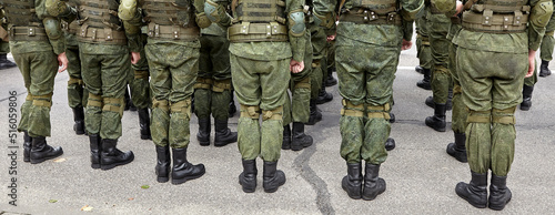 Soldiers in military camouflage uniforms in army formation.
