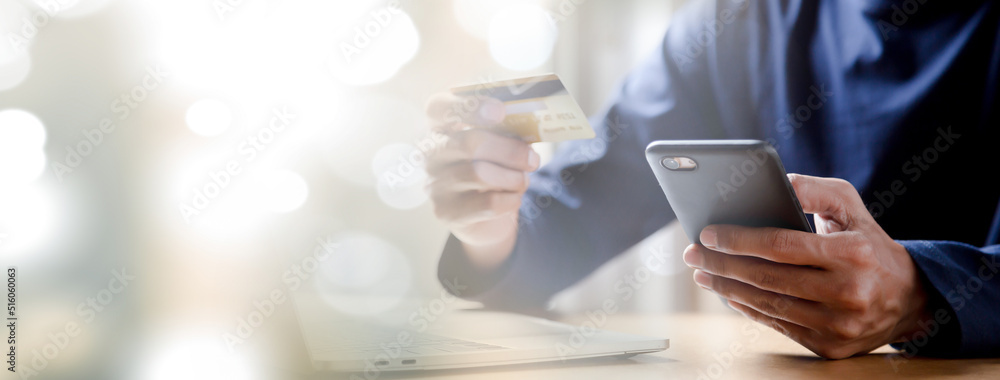 Man holding credit card and using smartphone at home online shopping ecommerce internet banking spend money work from home concept. Man holding credit card and using smartphone at home online shopping ecommerce internet banking spend money work from home concept.