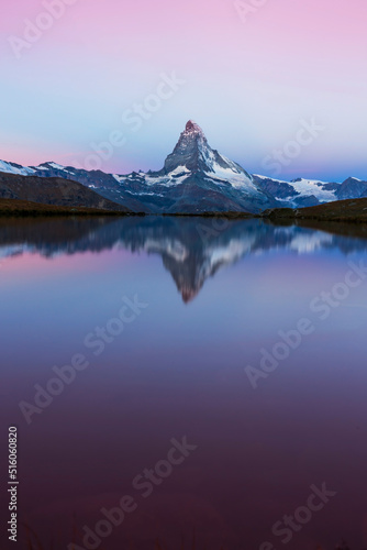 Beautiful sunset colors and cloudscape in the Swiss Alps in summer, with Matterhorn reflection in a lake