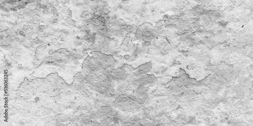Peeling paint on a gray concrete wall. White painted abstract background, grunge cracked surface, beton pattern texture. Empty space.