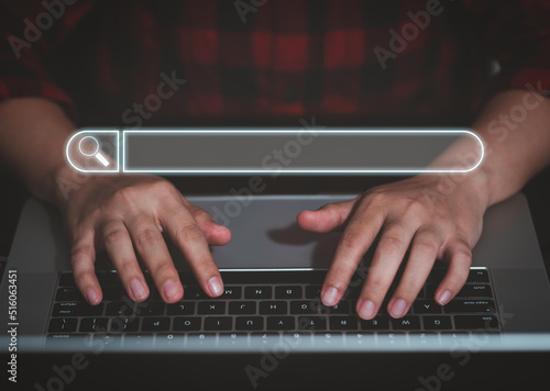 SEO Search Engine Optimization, online Internet browsing web, digital content concept. Woman using laptop with search bar magnifying glass graphic on virtual screen, banner