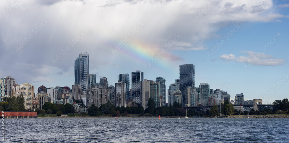 Downtown Vancouver City Skyline with clouds and rainbow. False Creek, British Columbia, Canada. Modern Cityscape on West Coast of Pacific Ocean.