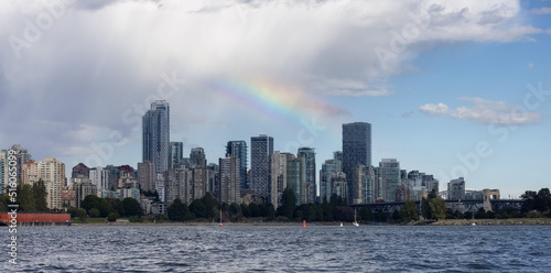 Downtown Vancouver City Skyline with clouds and rainbow. False Creek, British Columbia, Canada. Modern Cityscape on West Coast of Pacific Ocean.