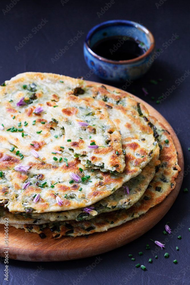 Homemade appetizing scallion pancakes served with soy sauce.