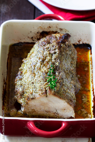 Obraz na płótnie Pork loin baked with herbs, served in a baking dish. Rustic style. w salonie