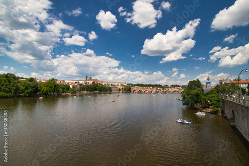 Pedal boat on Vltava river  Charles bridge and Prague Castle in background.