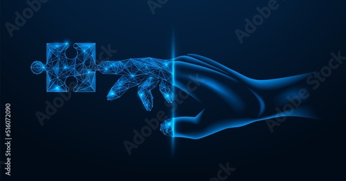 A piece of the puzzle on the finger of the hand. Part of a virtual project. Transition to the digital space. Polygonal design. Blue background.