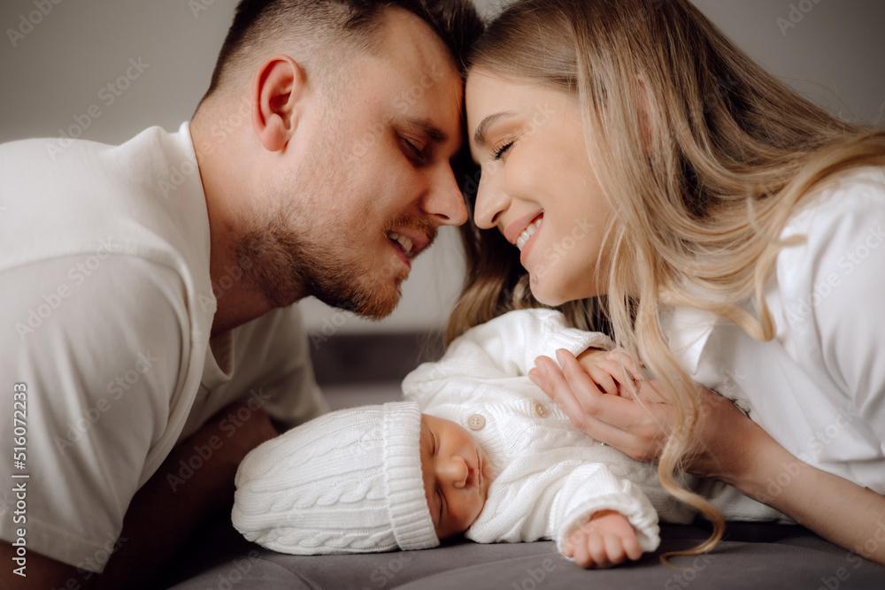 parent and baby, parents and newborn baby on the bed parent and baby, parents and newborn baby on the bed