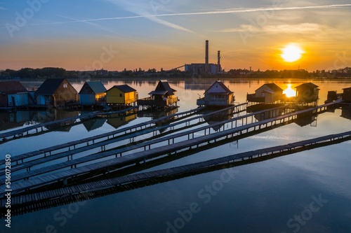 Sunset over the famous tourist attraction: fisherman cabin, floating house on Bokodito at Lake Bokod - Hungary. photo