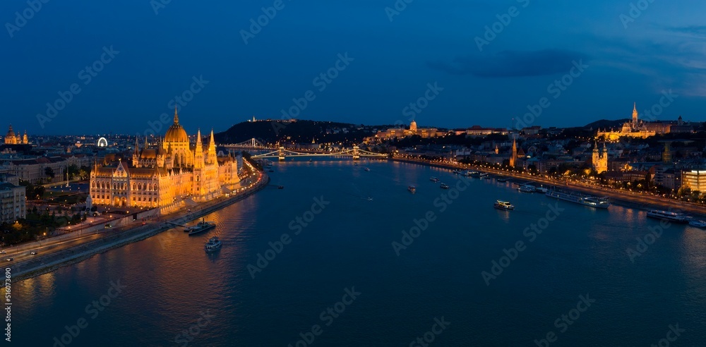 Budapest by night - panorama drone photo of Budapest, Hungary, river Danube, the Parliament, Chainbridge and the Buda Castle and Royal Palace.