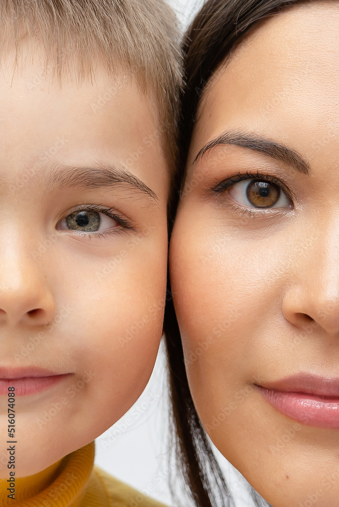 half face of son and mother close up. two halves of the face of the parent and child, similar eyes. concept of generation, genetics and heredity