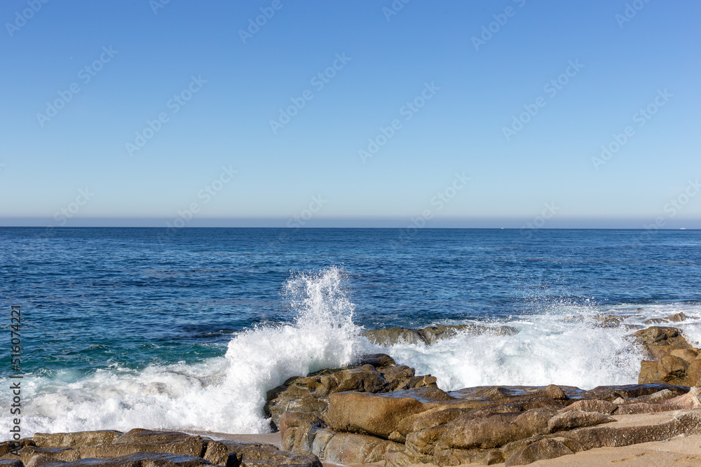 Fototapeta premium A view on the ocean with the rocks and waves