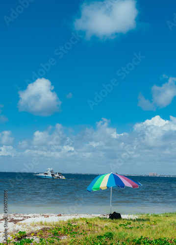 umbrellas on the beach boat sea sky clouds miami